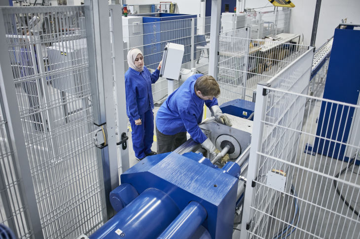 In this method, the metal is heated and then pressed through a die using the extrusion press. Photo: Hereon/Rolf Otzipka Scientists working